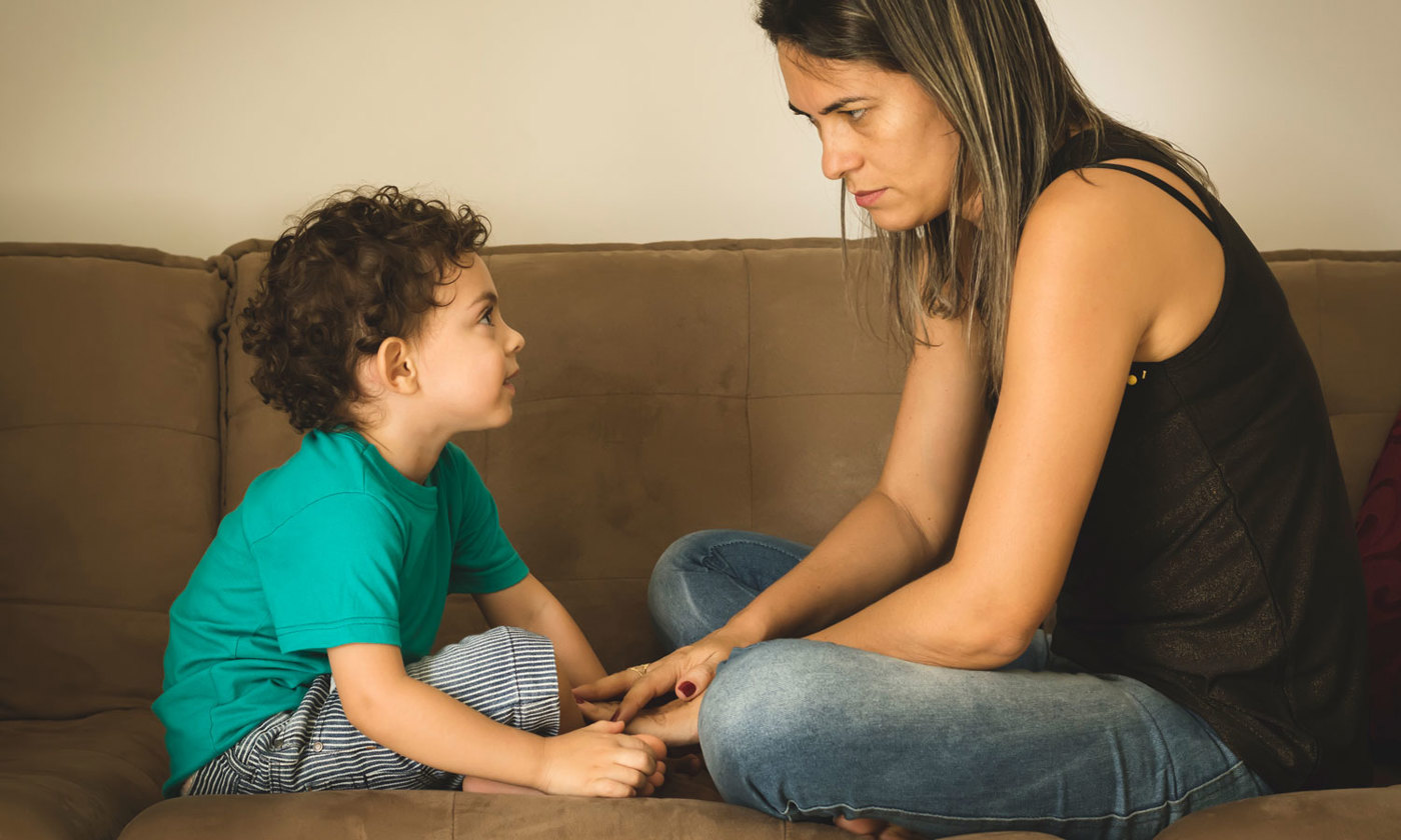 Mother speaking seriously to her son