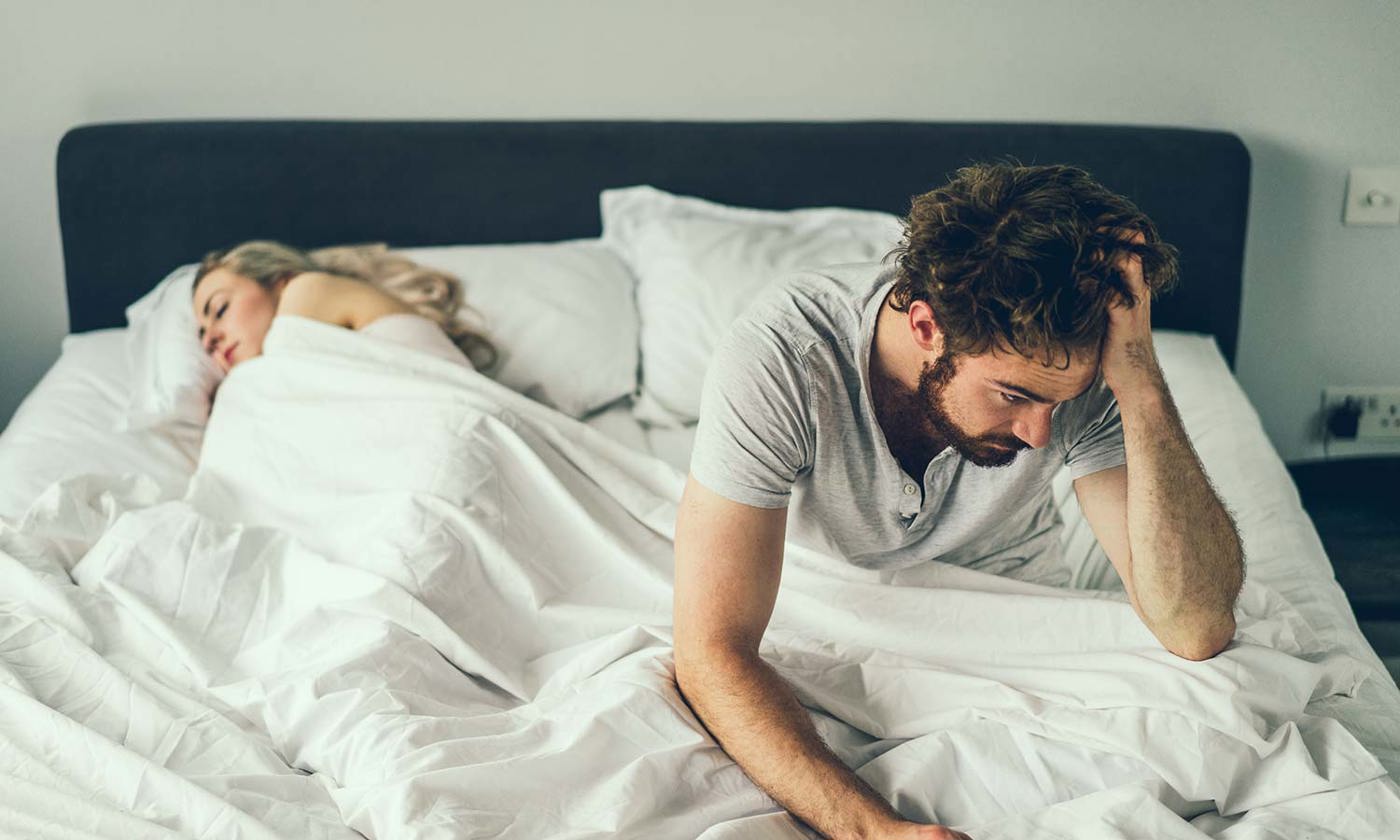 Tired man waking up in the morning