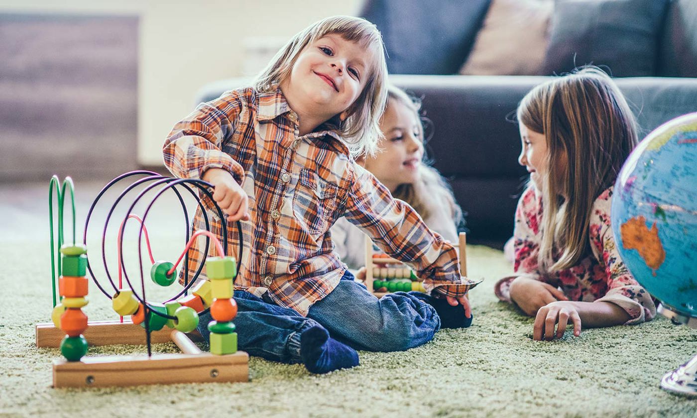 Children playing on floor with toys