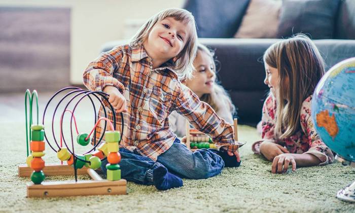 Children playing on floor with toys