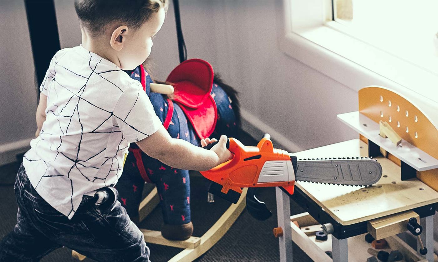 Boy with toy chainsaw