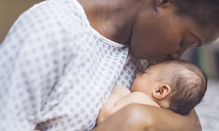 Mother holds newborn