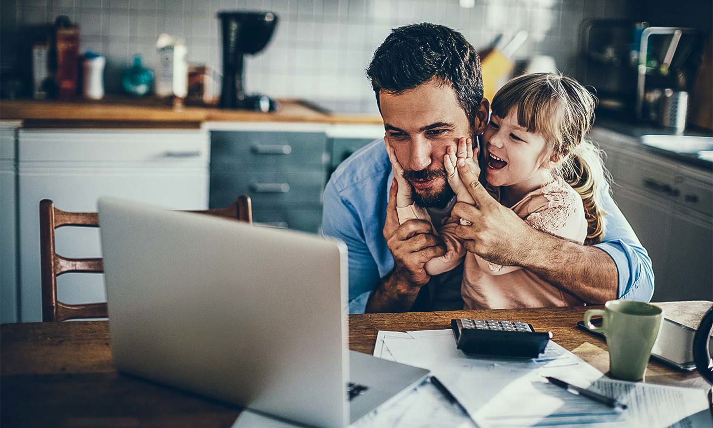 Father and daughter working at computer