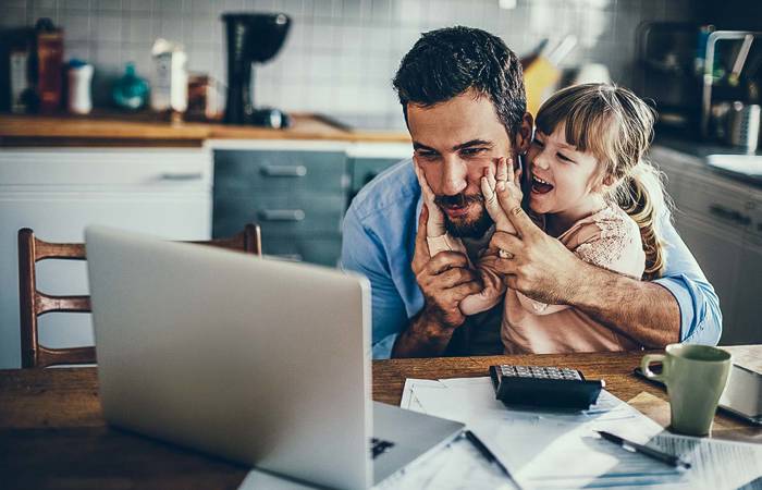 Father and daughter working at computer