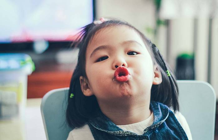 Toddler girl pulling faces