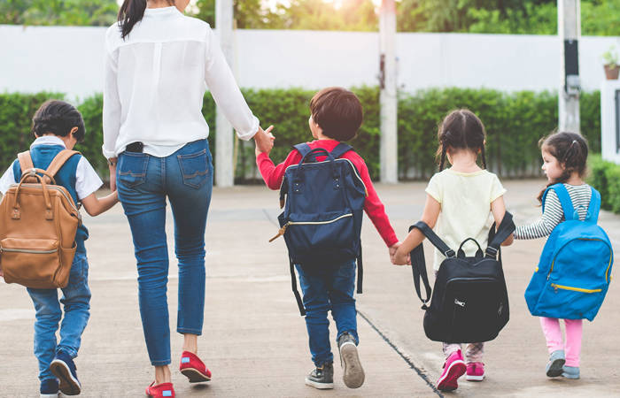 Mother with children going to school and preschool