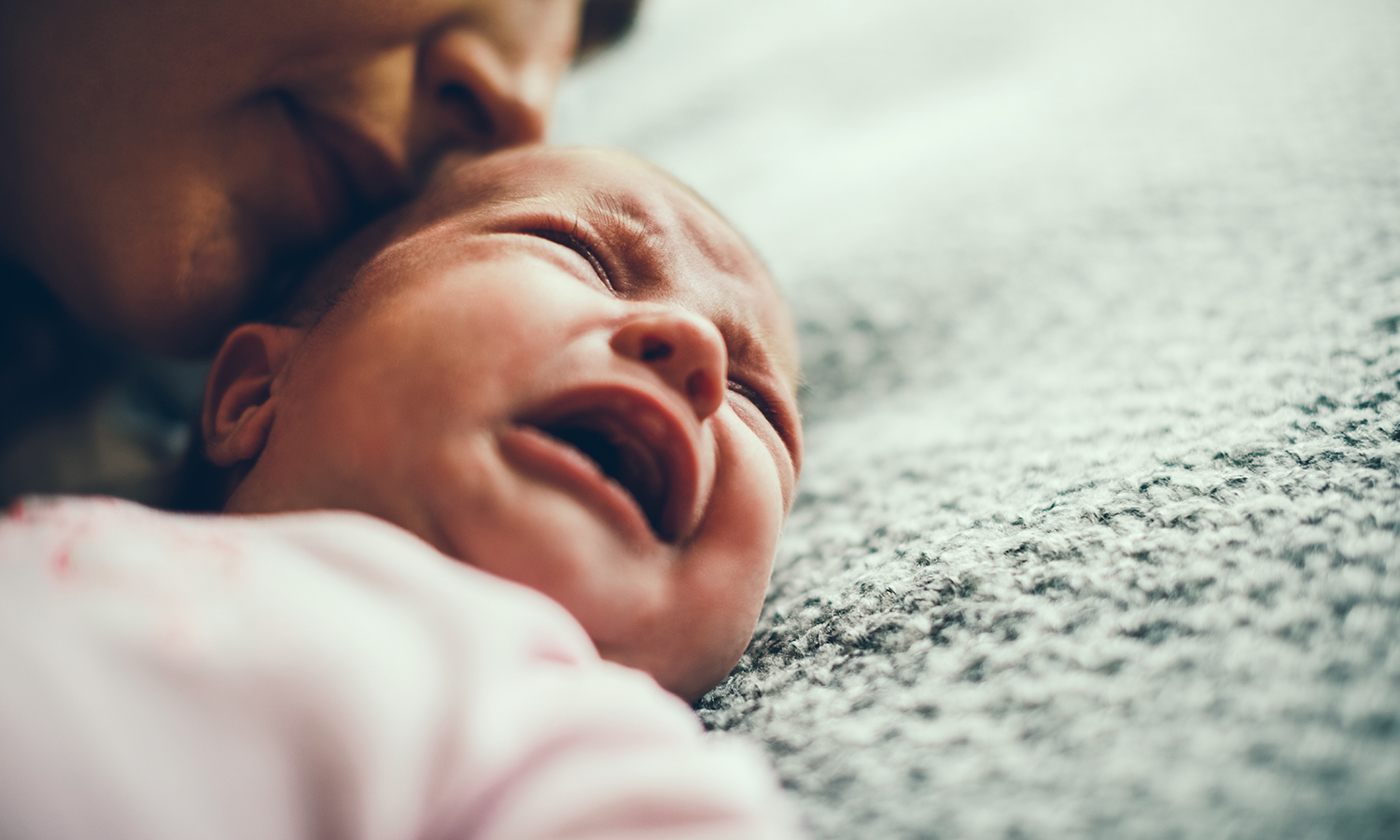 Mother calming her crying baby girl