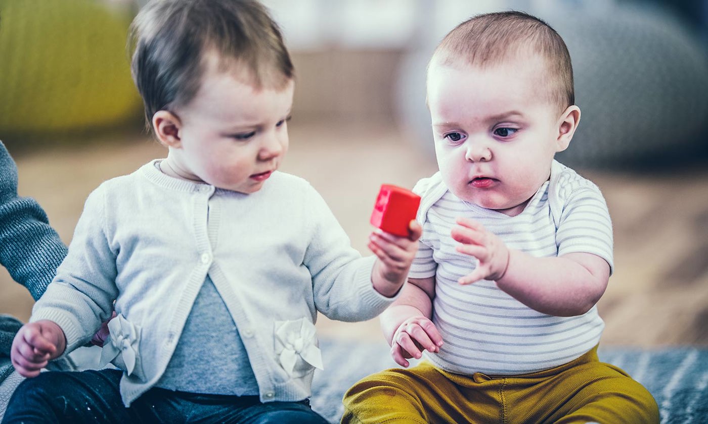 Toddlers sharing and playing