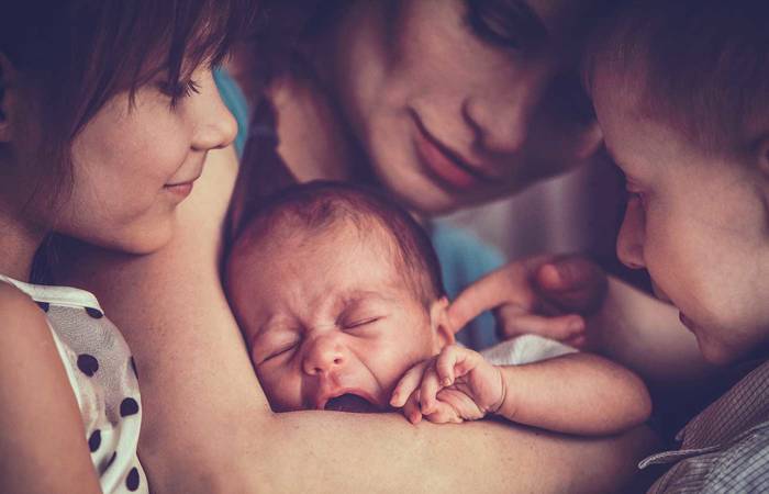 Mother with new baby and two children