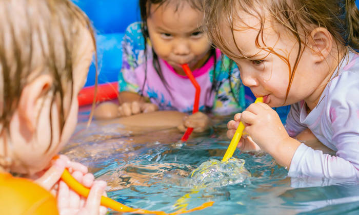 Three children playing with water