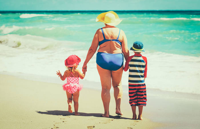 Grandmother with grandchildren at the beach