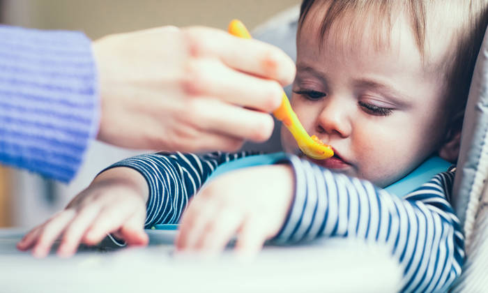Boy refusing food at meal time