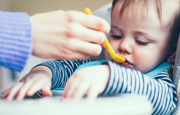 Boy refusing food at meal time