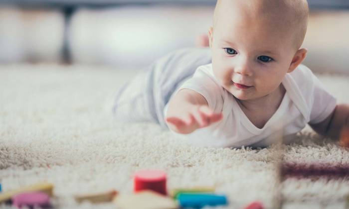 Baby on the floor with coloured blocks