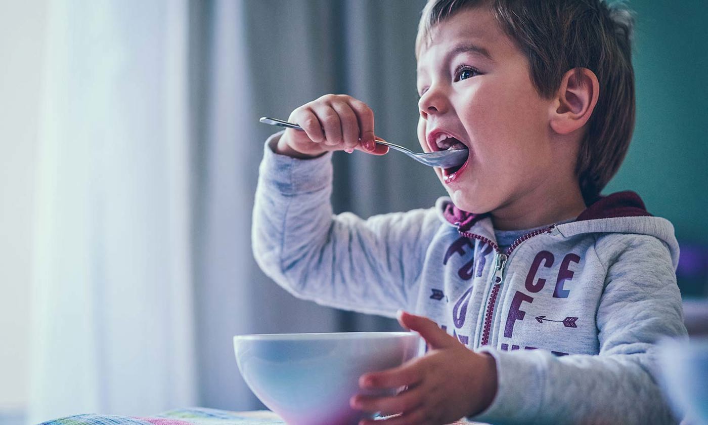 Little boy eating breakfast