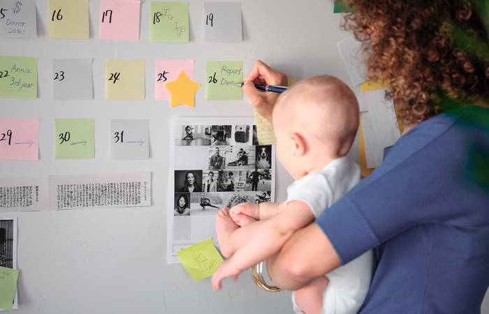 Working mother balancing baby