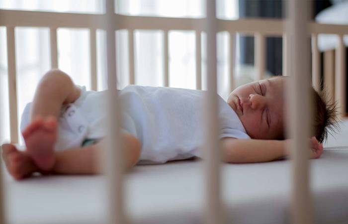 Baby sleeping in cot