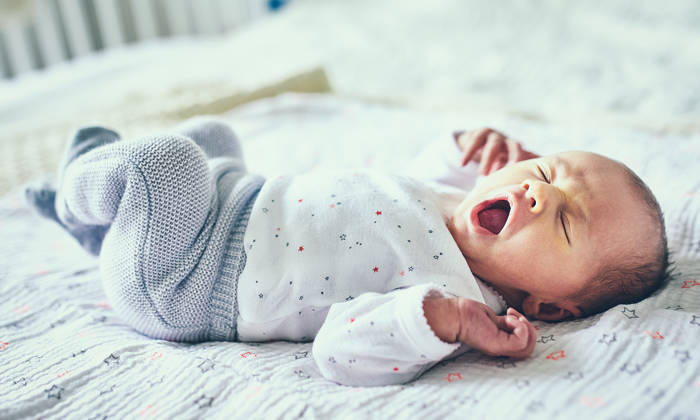 Newborn baby girl yawning