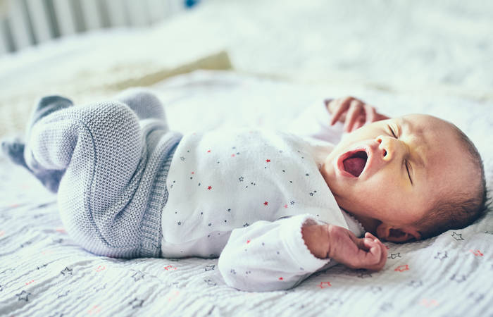 Newborn baby girl yawning