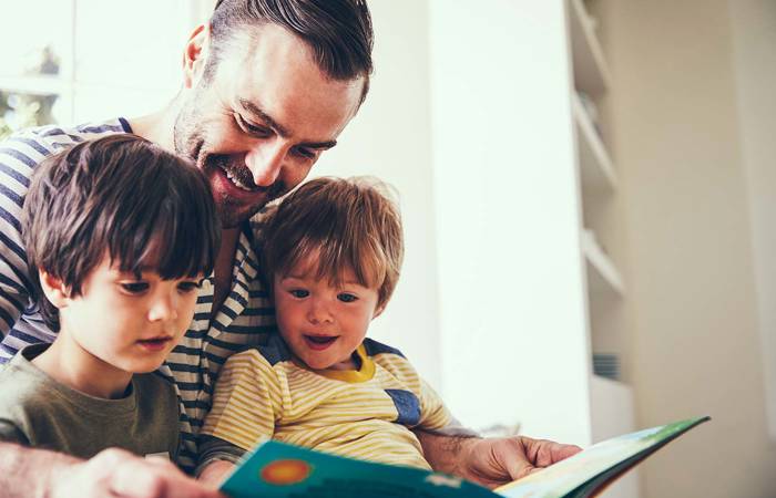 Father and sons reading