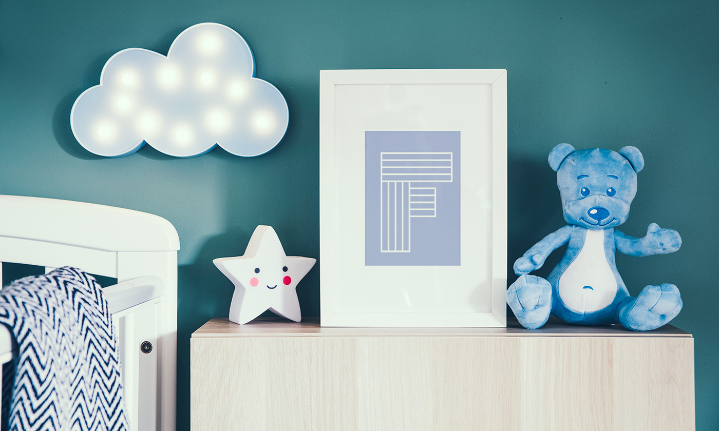 Nursery interior with photo frame, teddy bear, star and blue cloud