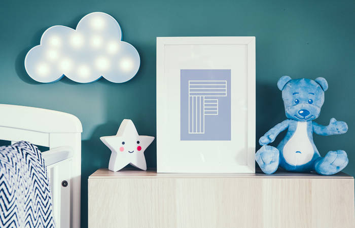 Nursery interior with photo frame, teddy bear, star and blue cloud