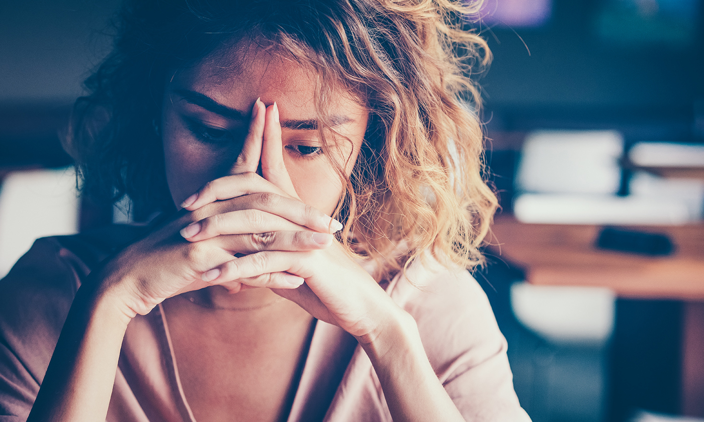 Tired woman leaning on hands