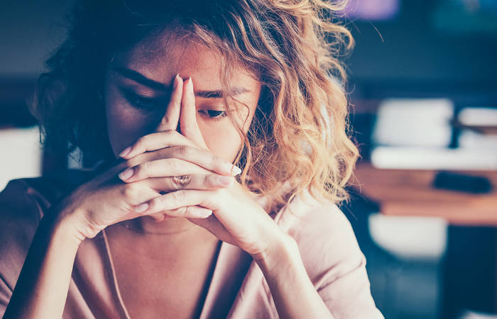 Tired woman leaning on hands