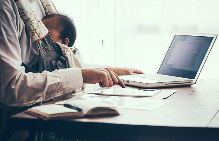 Father with baby working at home