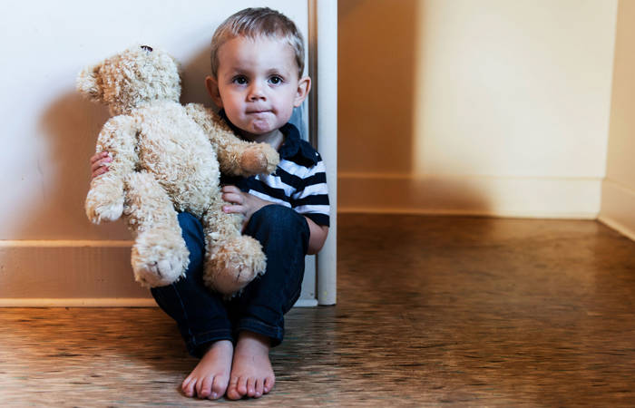 Upset child sitting on the floor