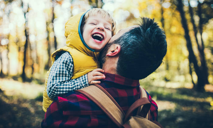 Father holding son in the outdoors