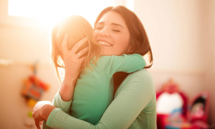 Mother is hugging her daughter