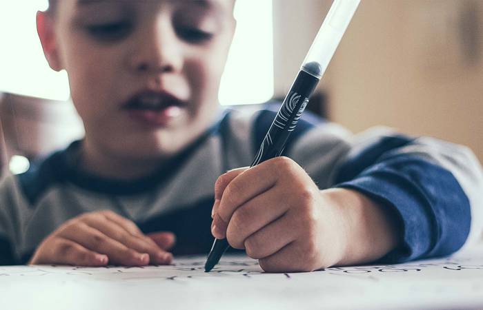 boy writing with a pen