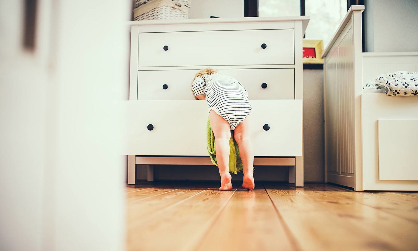 Toddler boy in a dangerous situation at home