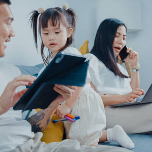 Mother and father working with children on lounge