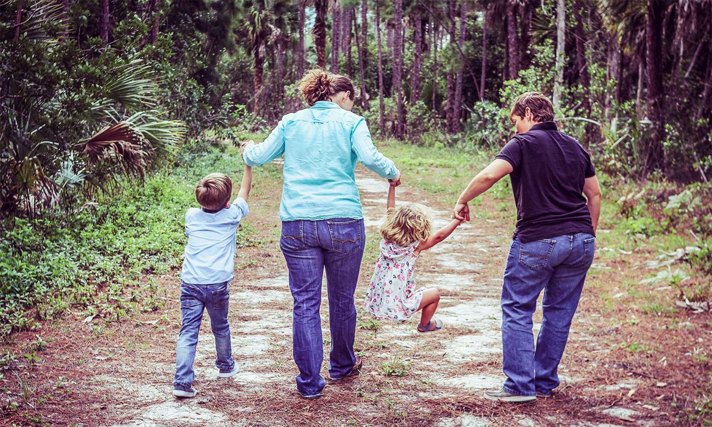 two mums walking on track with their children