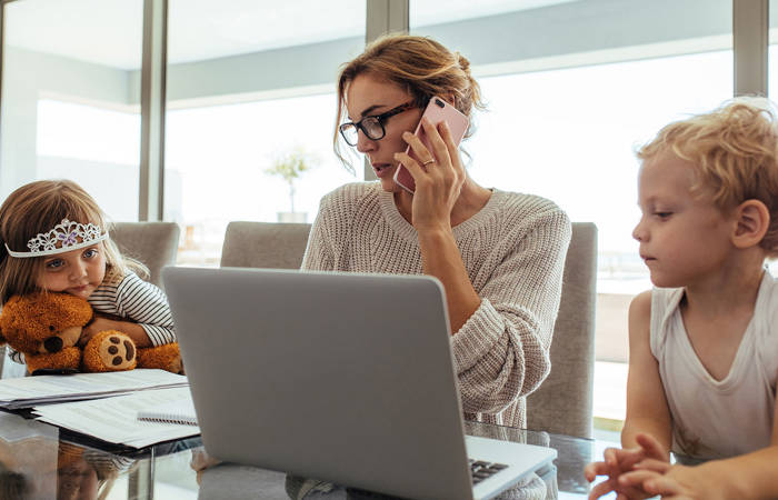 Mother working and looking after two children