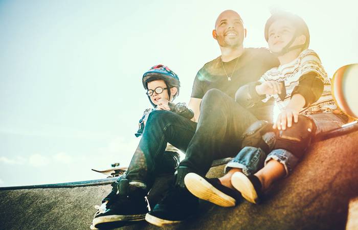 Father and sons skateboarding